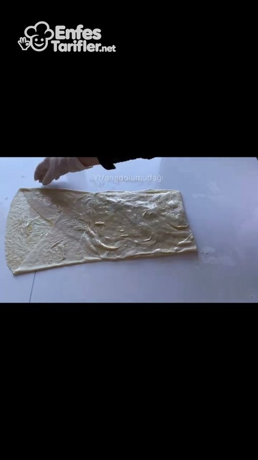 Tezgâhta dikdörtgen biçiminde açılmış ve yüzeyi yağlanmış börek hamuru
